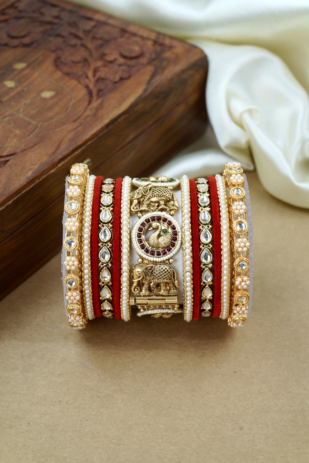 Decorative bracelet with intricate design on a wooden surface by hitesh bangles