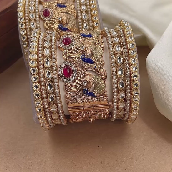 Elegant bridal gold-plated Kundan bangles featuring peacock motifs, red ruby stones, blue enamel detailing, and traditional Indian craftsmanship, perfect for wedding wear by hitesh bangles