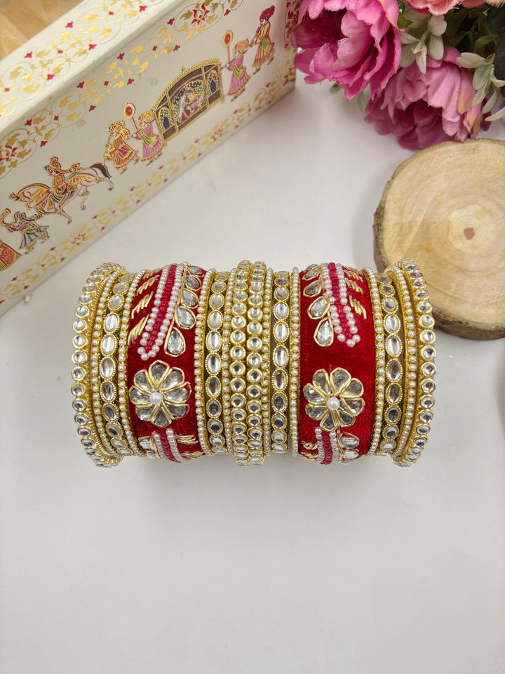 Red and gold bridal chura set adorned with Kundan stones