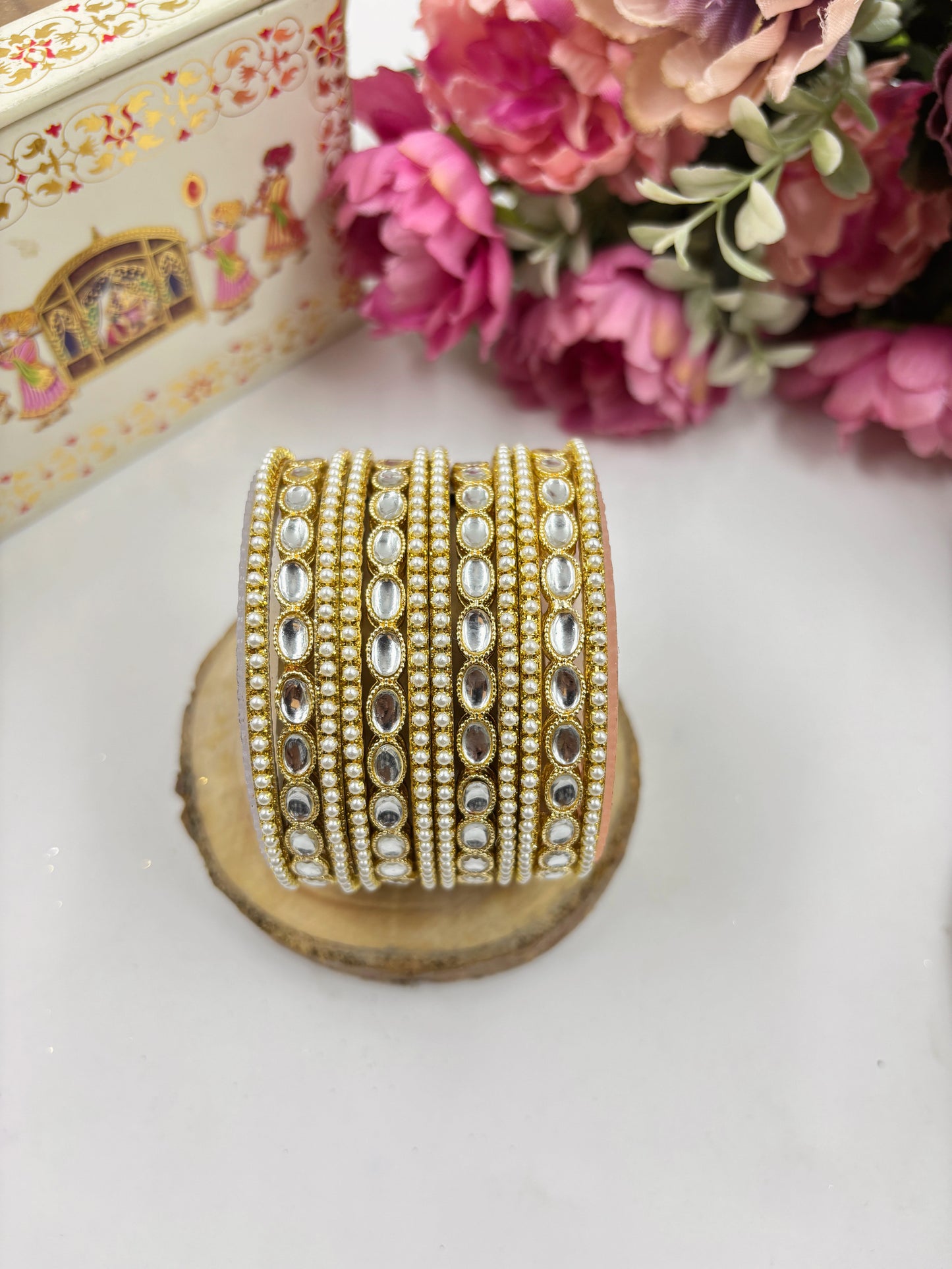 Set of pearl and Kundan bridal bangles with mirror-cut Kundan stones and pearl detailing by hitesh bangles